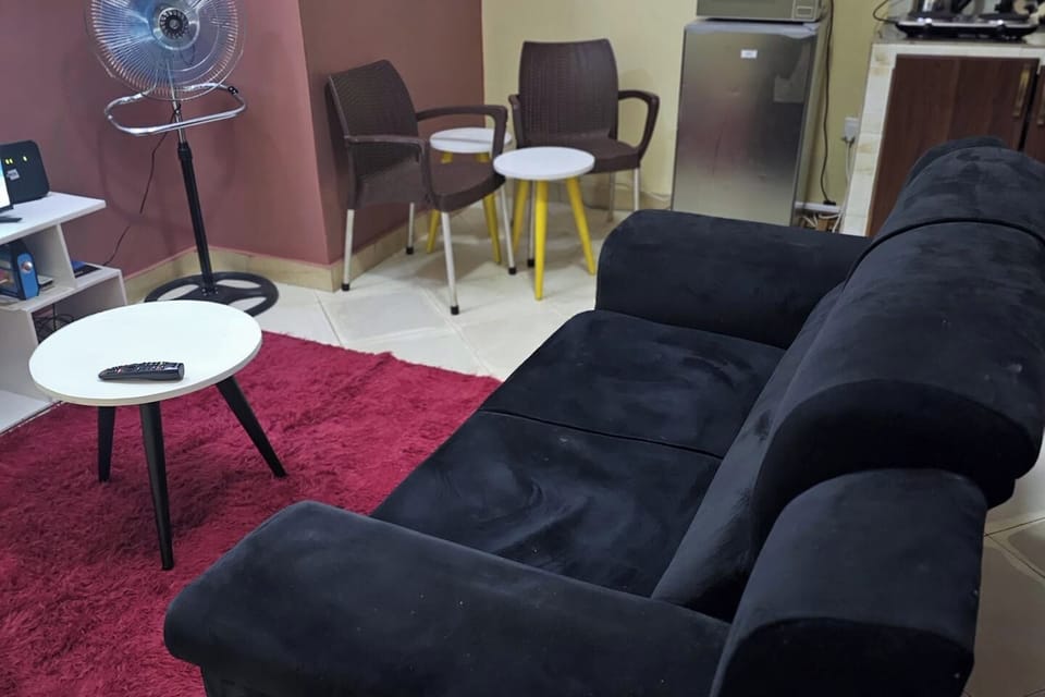 Lounge area with Powerful Fan, 2 seater sofa, Fast Unlimited Wifi + secondary seating area which has a nest of tables.