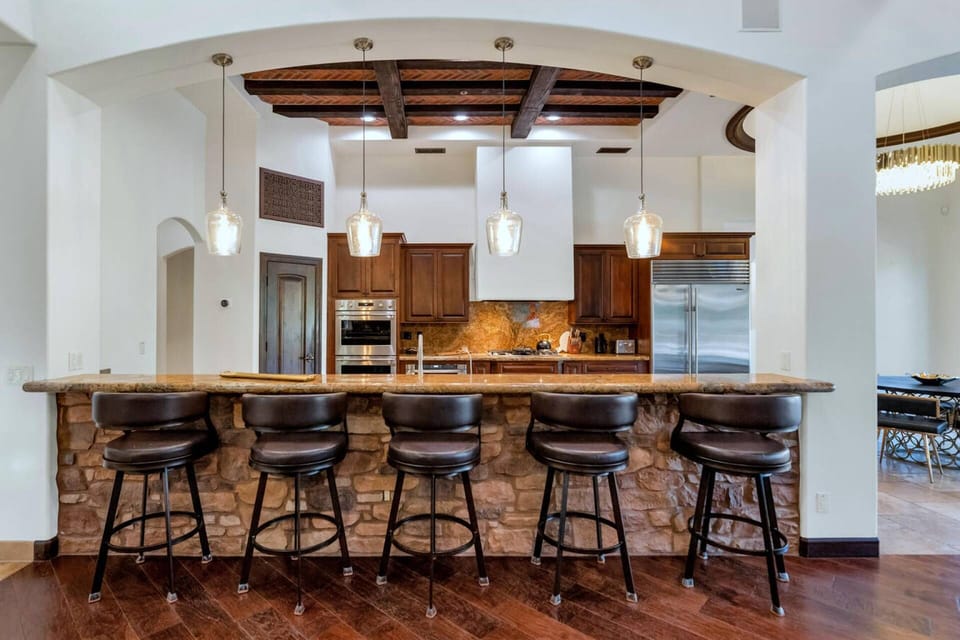 Spacious kitchen featuring huge breakfast bar with 5 bar stools