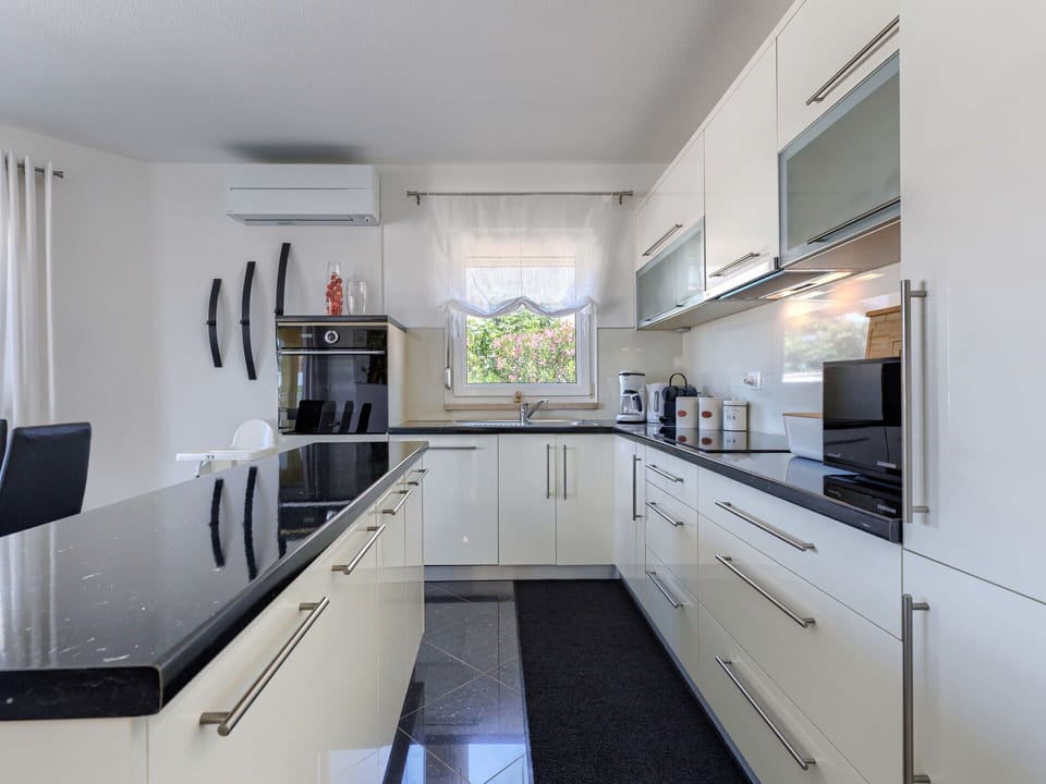 Kitchen, Countertop, Flooring, Kitchen Appliance, Furniture, Interior Design, Cabinetry, Home, Floor, Lighting