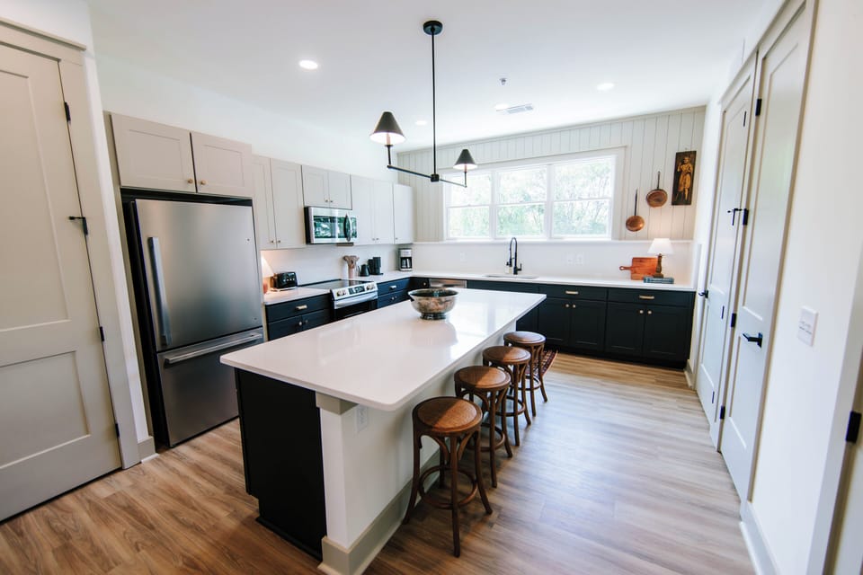 Discover culinary bliss in this modern kitchen featuring a spacious island table, perfect for cooking and gathering. With sleek appliances and modern finishes, it's designed for both functionality and flair.