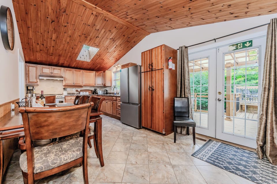 Enjoy cooking in this spacious, well-equipped kitchen with modern appliances, beautiful wood cabinetry, and a skylight that lets natural light flow in.