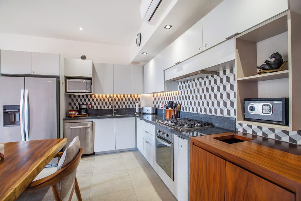Sleek kitchen featuring stainless steel appliances and a stylish design