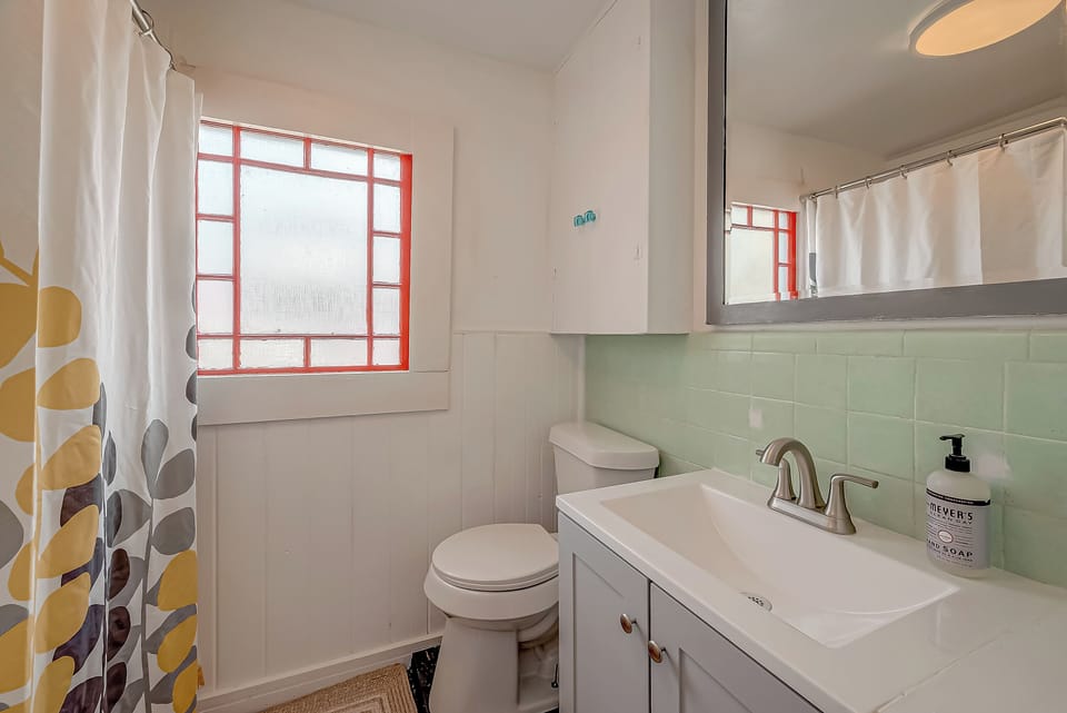Cute bath with circa window!