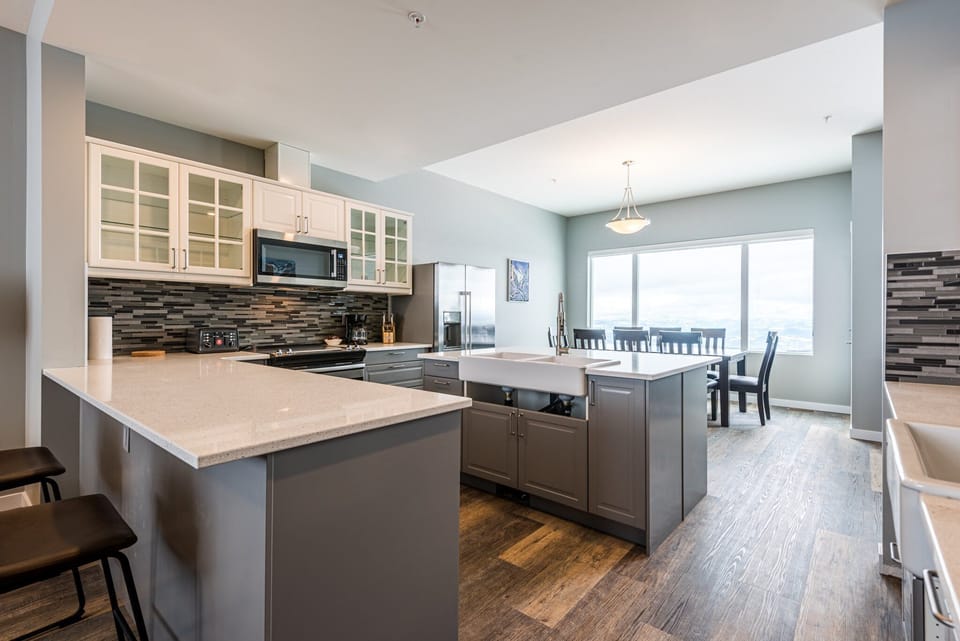 Stairs leading upstairs to the bedrooms is to the right of the dining table.
