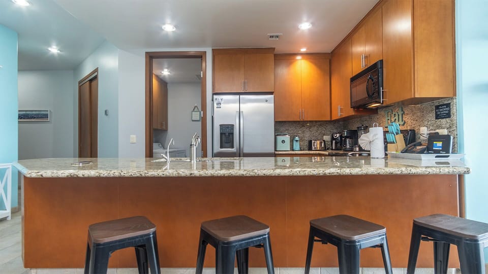 Four high bar stools at the kitchen counter make great use of the space.
