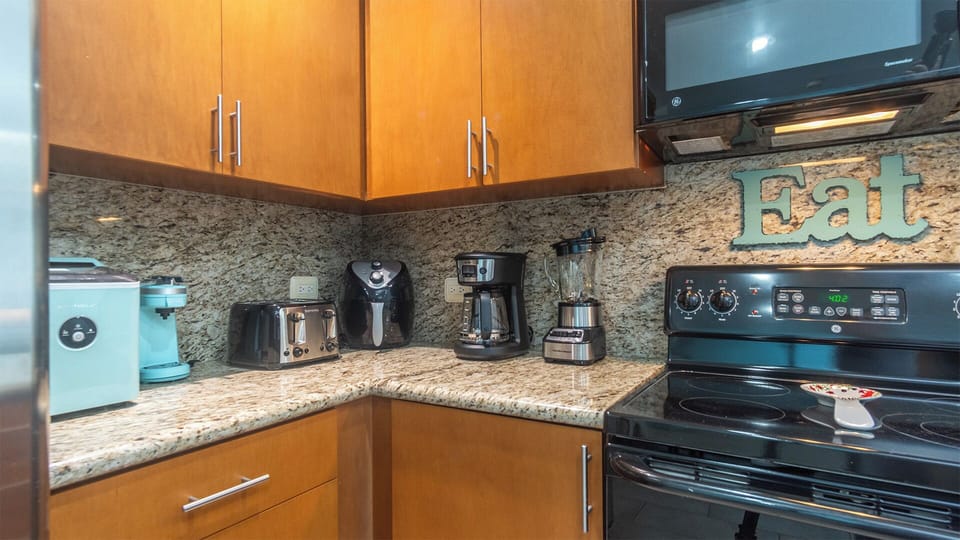 Many small appliances in th kitchen.