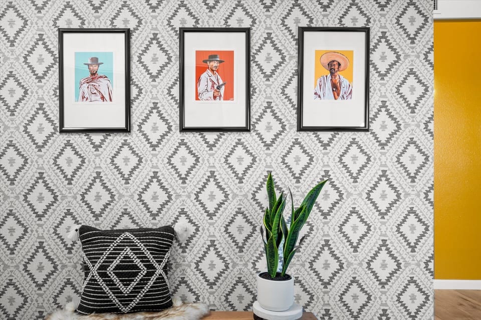 Above, three framed cowboy portraits capture the essence of the Wild West