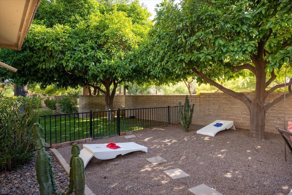 Enjoy outdoor fun with cornhole in our backyard, a favorite pastime for all ages