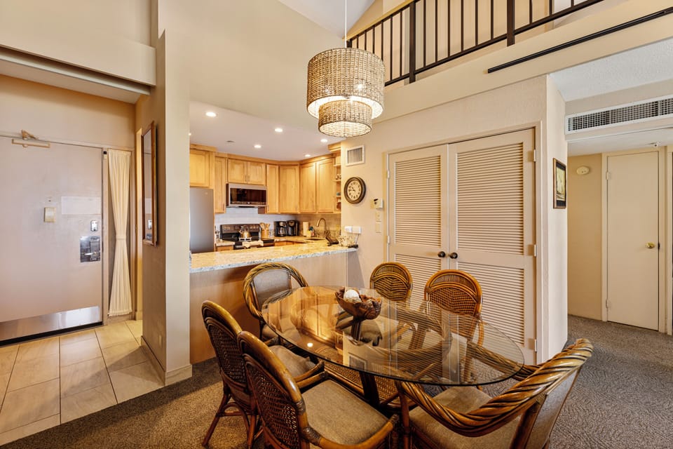Enjoy meals with family or friends in this inviting dining area, complemented by an open kitchen with beautiful granite countertops and wood cabinetry.