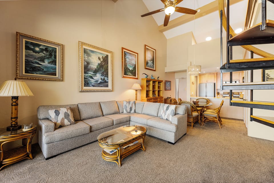 Enjoy meals with family in the spacious dining area or relax in the open-plan living room, both featuring tropical décor and high ceilings for a breezy island vibe.