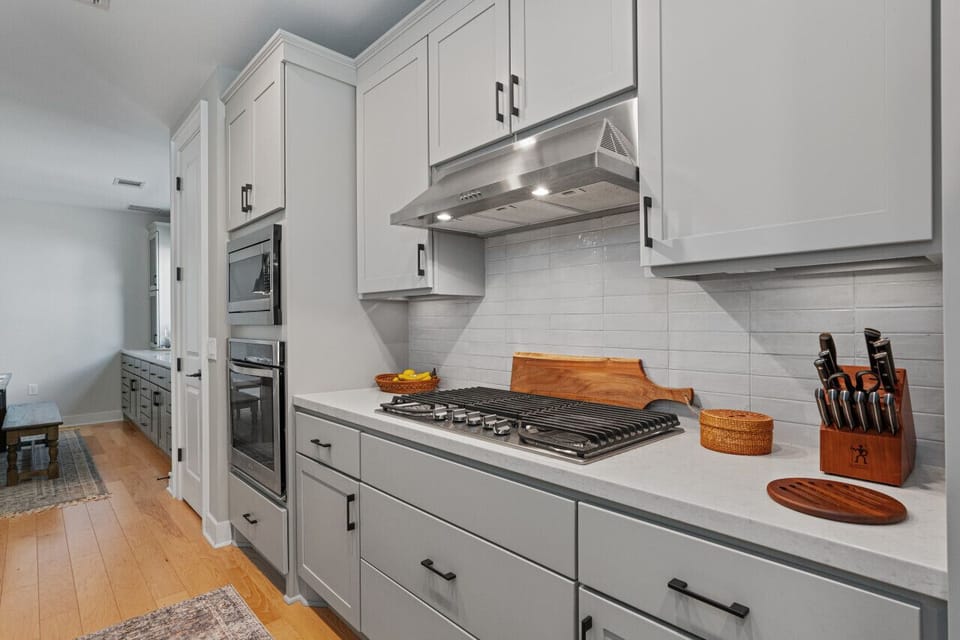 Bright kitchen with a large island, ideal for cooking and socializing. Equipped with sleek appliances and plenty of counter space.