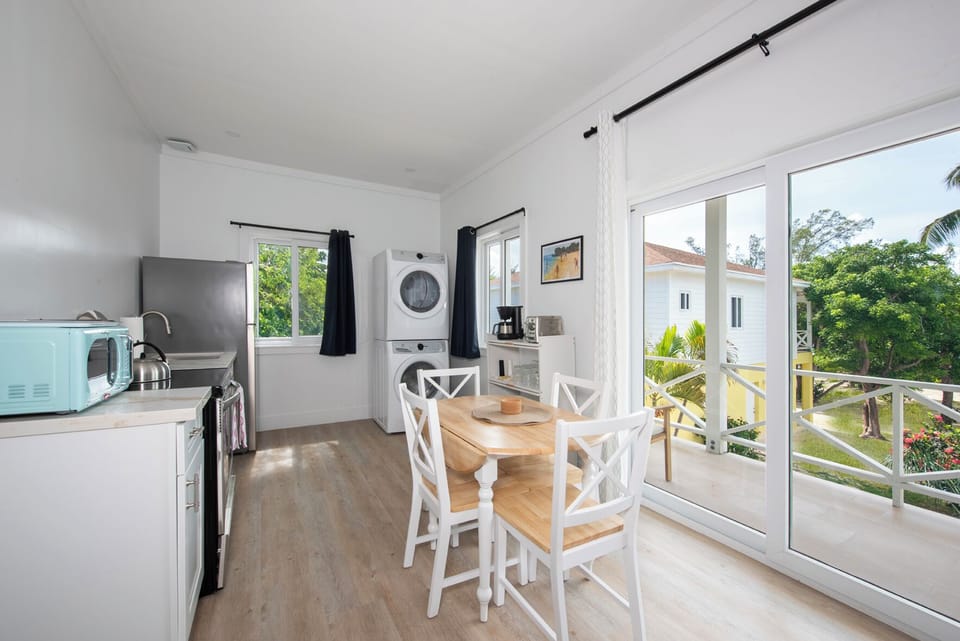 Fully equipped kitchen with laundry and dining area.