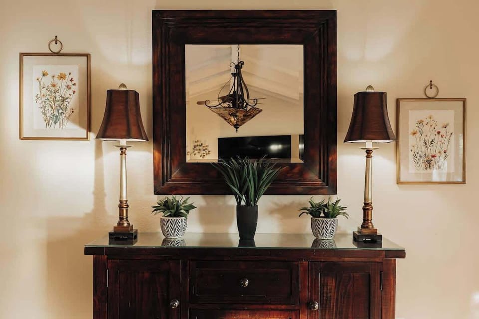 Relax in your elegantly appointed living space, where warm wood furnishings and thoughtful botanical touches create the perfect atmosphere for unwinding.