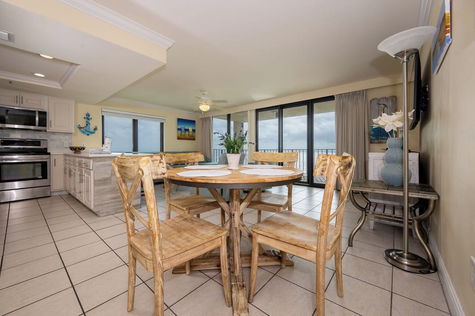 The kitchen features stainless appliances, a cozy dining area, and breathtaking views from the large windows