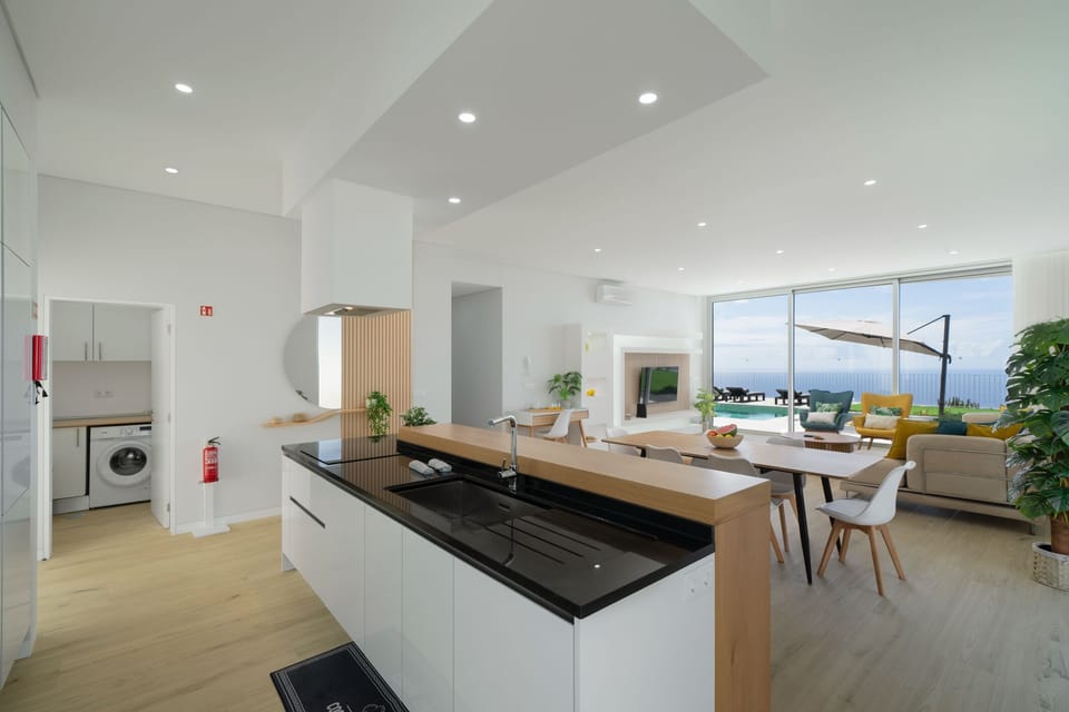 The Contemporary Kitchen Island Of Villa Adagio By Ourmadeira Showing Those Amazing Views Over The Pool To The Sea