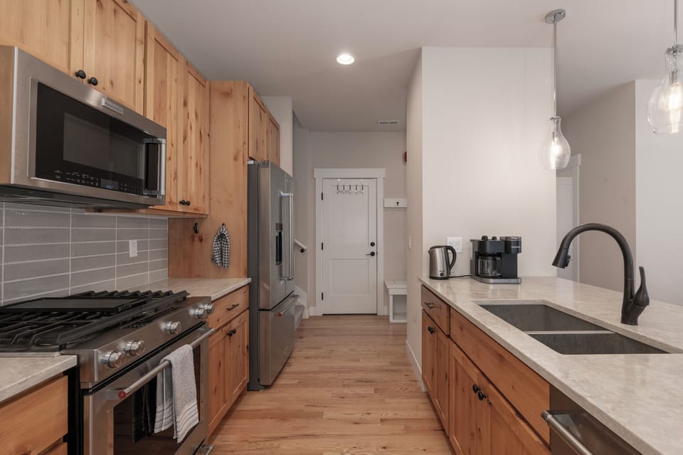 Our spacious galley kitchen is stocked with pots, pans, and dinnerware for you and your guests.