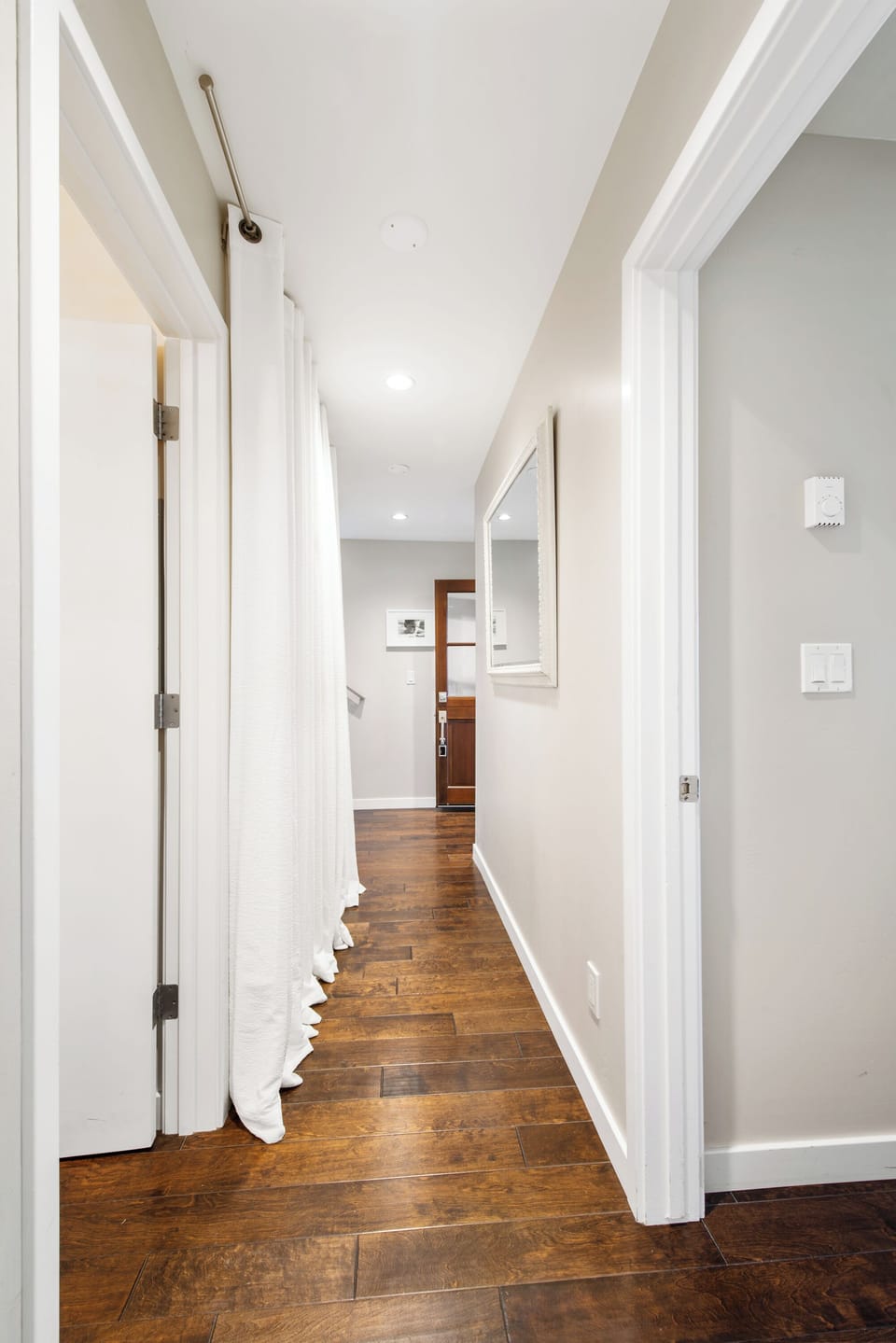 Downstairs hallway. washer/dryer behind curtain