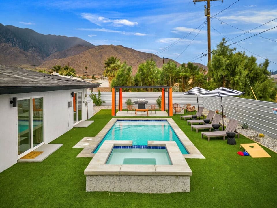 Sunlit backyard w/ a sparkling pool, loungers & mountain views—perfect for cooling off or soaking up the desert vibes.