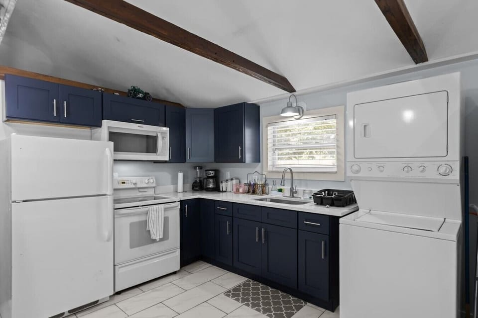 Fully stocked kitchen with pots, pans, cooking supplies, blender, toaster, steam cooker, coffee