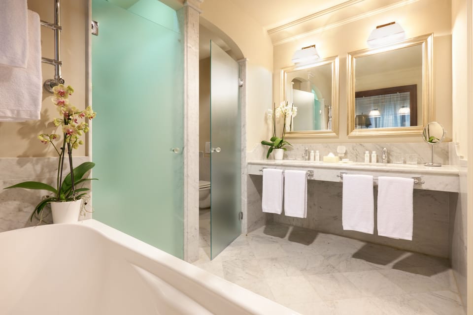 Suite, Pool View | Bathroom | Separate tub and shower, free toiletries, hair dryer, bathrobes