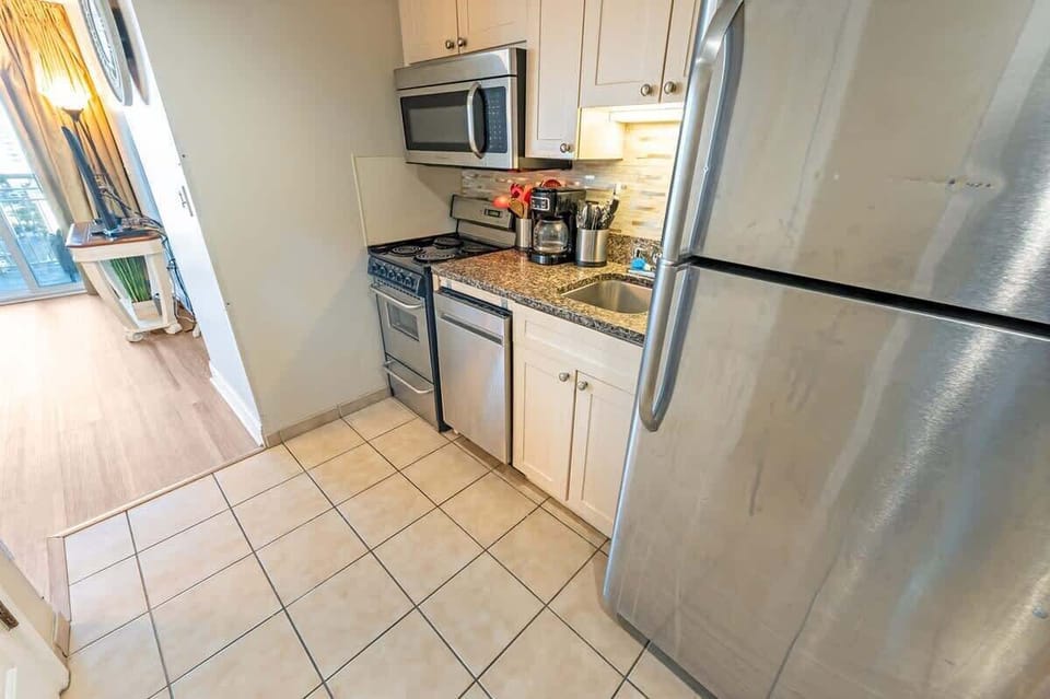- Modern kitchen featuring stainless steel appliances and granite countertops - Everything you need to whip up delicious meals, from morning coffee to gourmet dinners - Sleek & stylish design, perfect for those who love a home cooked experience 