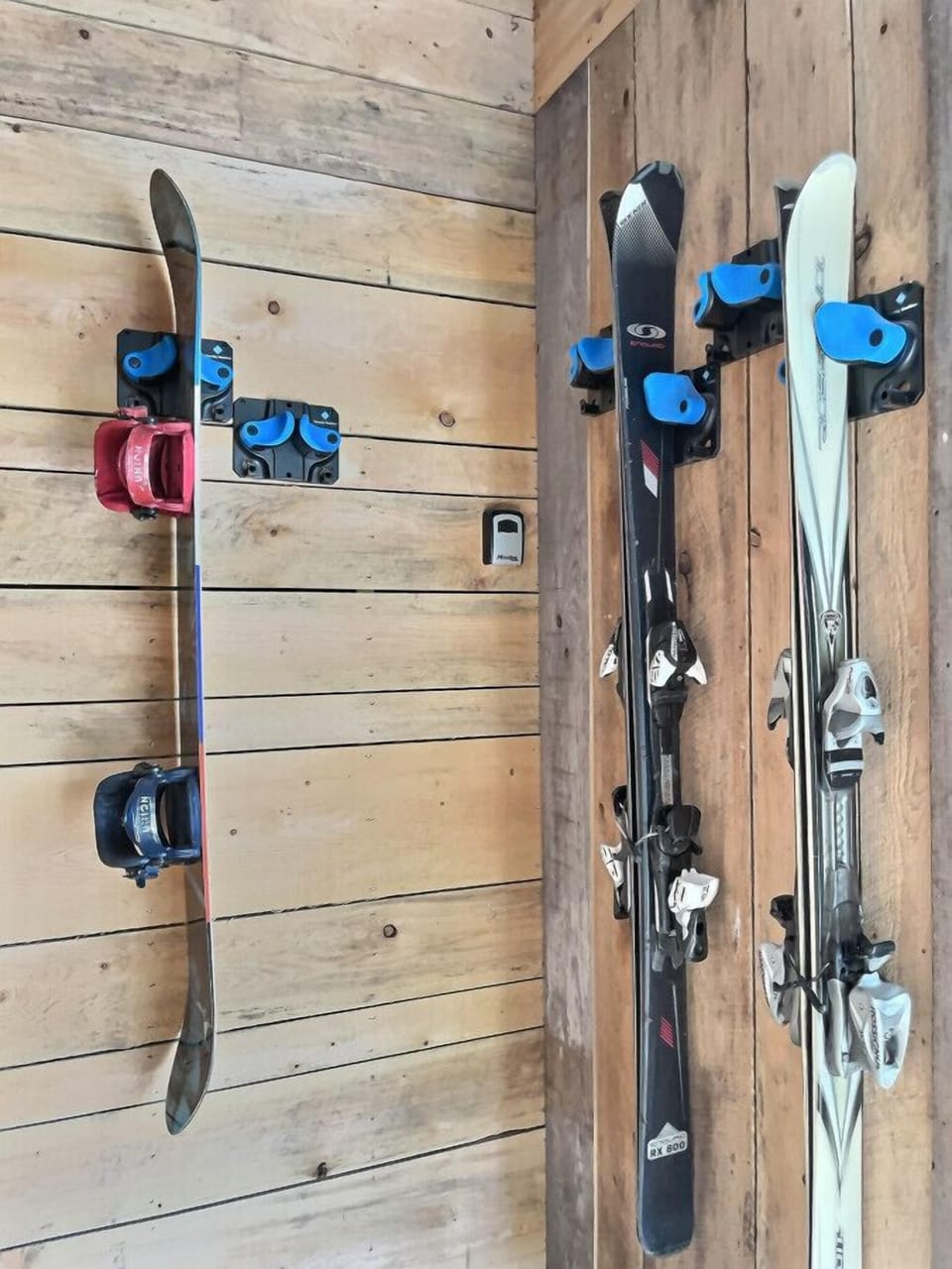 Convenient wall-mounted storage for skis and snowboards.