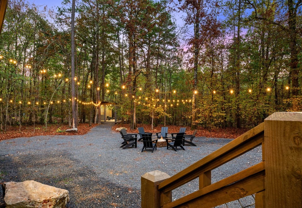 Twinkling lights and a cozy fire pit set the scene for memorable outdoor evenings filled with warmth and laughter.