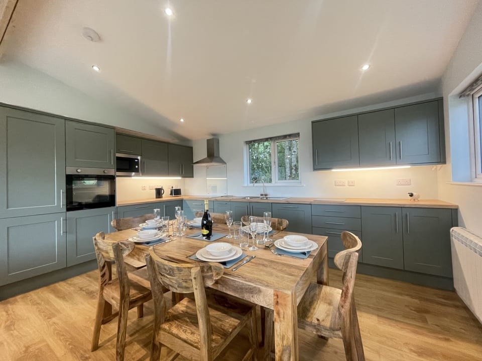 The modern kitchen is equipped with dishwasher, microwave, fridge/freezer, oven and electric hob