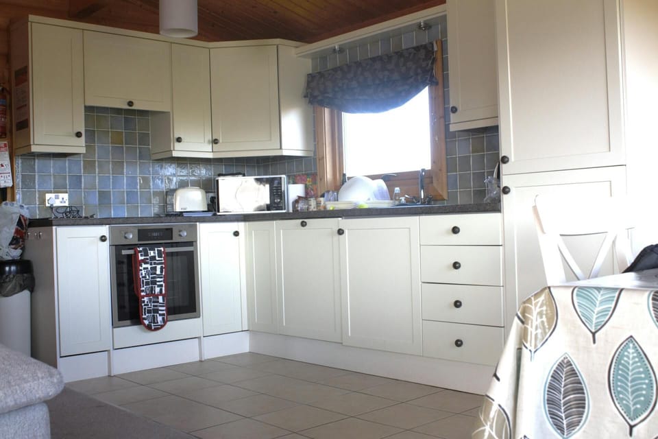 Fitted kitchen with electric cooker, toaster, kettle and microwave