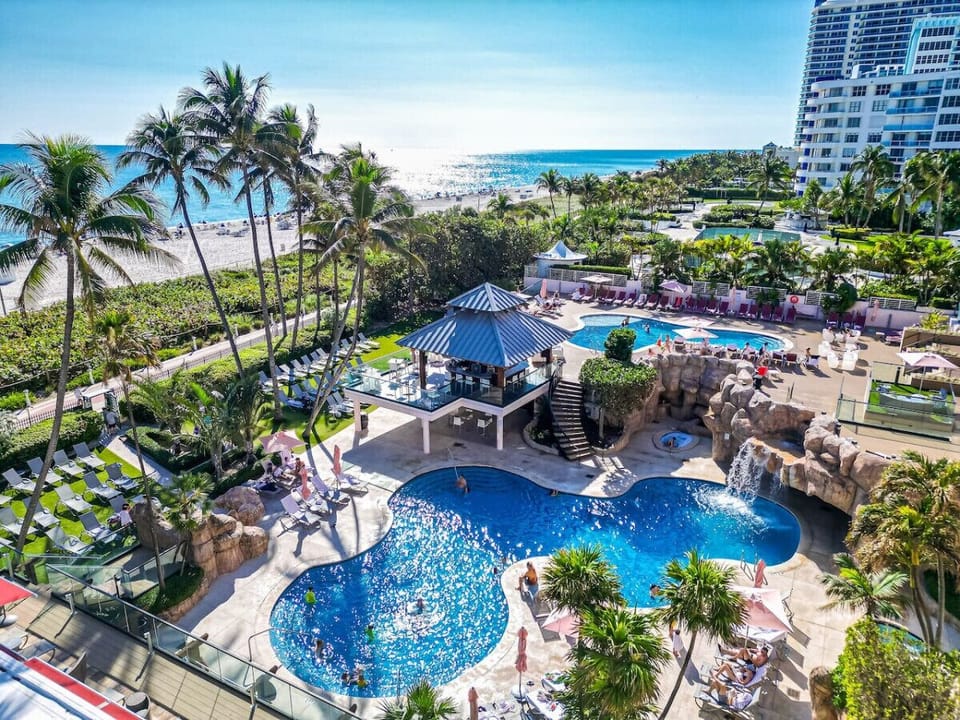 Two large resort pools, a jacuzzi, and a waterfall