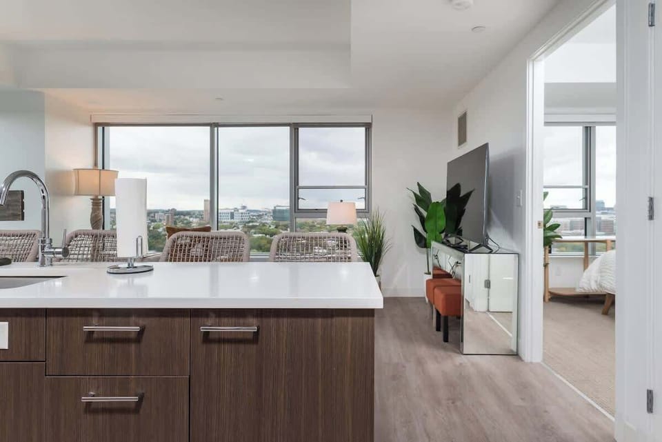 The living room, kitchen and dining area are all stitched together through a seamless open layout allowing for a spacious feel among the clean and modern interior. With a large kitchen island adding a touch of luxuriousness

