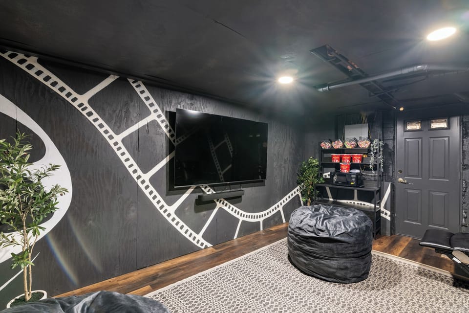 The theater room, 5 reclining theater seats, 75” Roku TV & surround sound