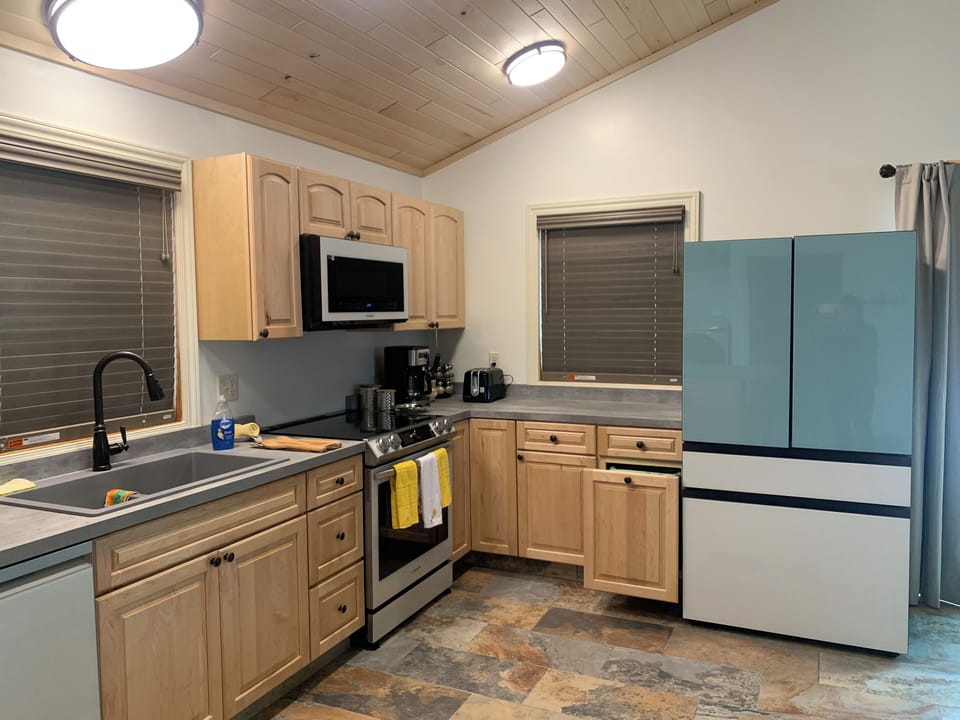 Kitchen with large Fridge and new range and oven