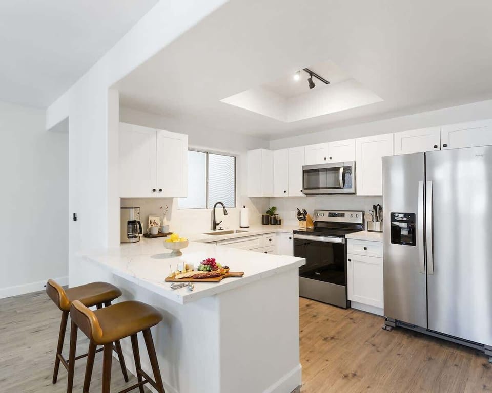 Sleek and fully equipped kitchen with stainless steel appliances, a spacious breakfast bar, and everything you need for home-cooked meals or quick snacks.