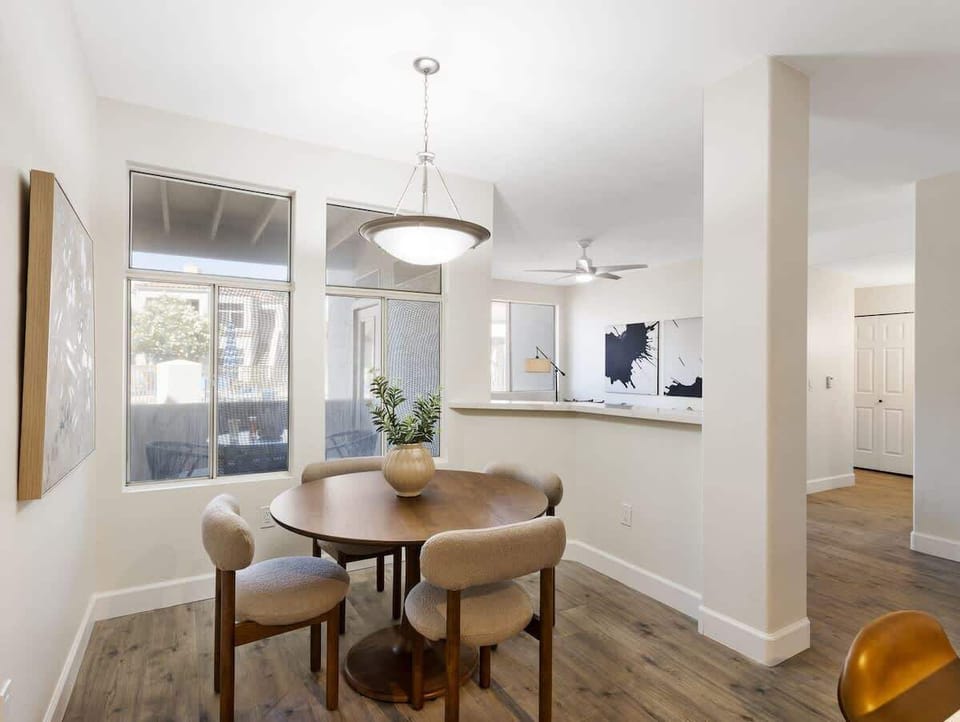Charming dining area with natural light and seating for four, offering a cozy spot for meals or conversation.