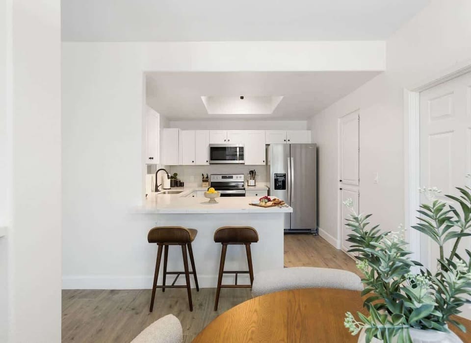 Sleek and fully equipped kitchen with stainless steel appliances, a spacious breakfast bar, and everything you need for home-cooked meals or quick snacks.