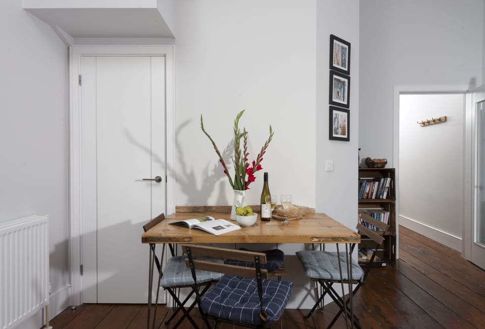 The Old Carriage Works, Lostwithiel, Fowey. First Floor: Dining table with seating for four guests