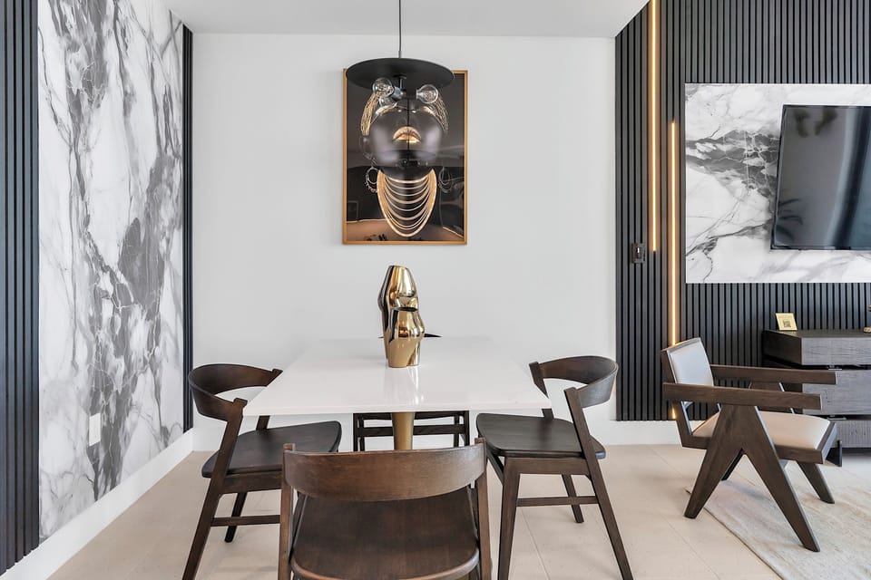 Dining area with a table for four and a beautiful artwork on the wall.