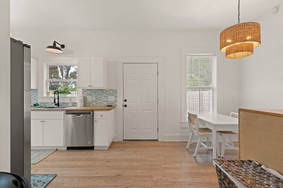 The hallway leads into a large, open kitchen at the back of the home.