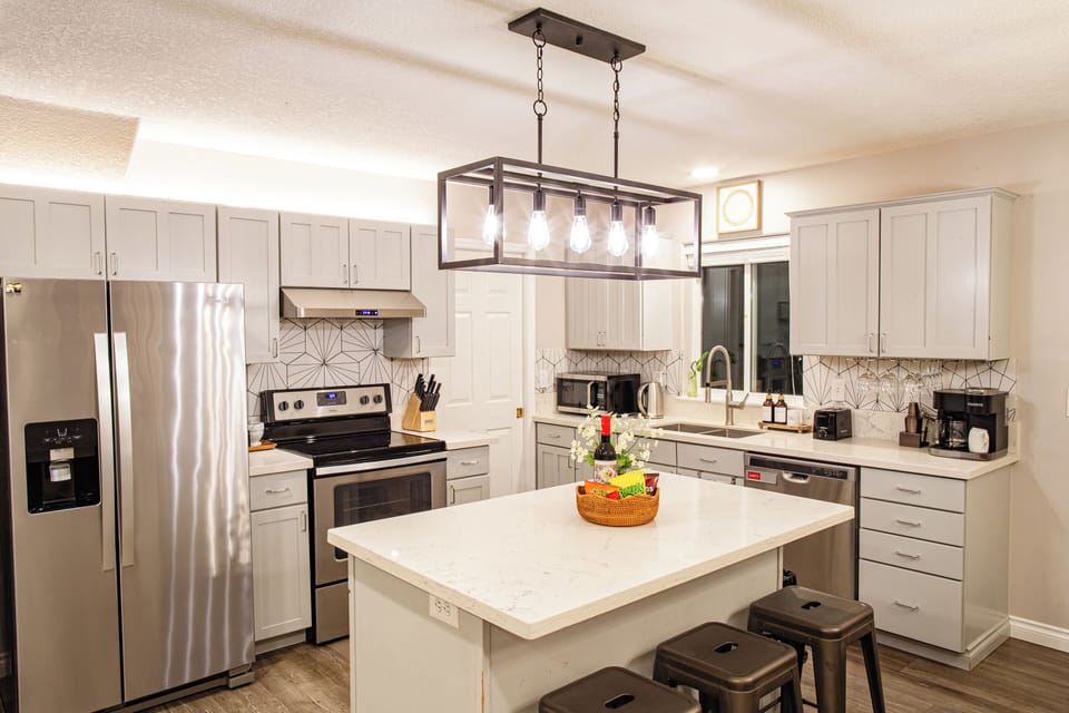 The fully equipped kitchen features all stainless steel appliances