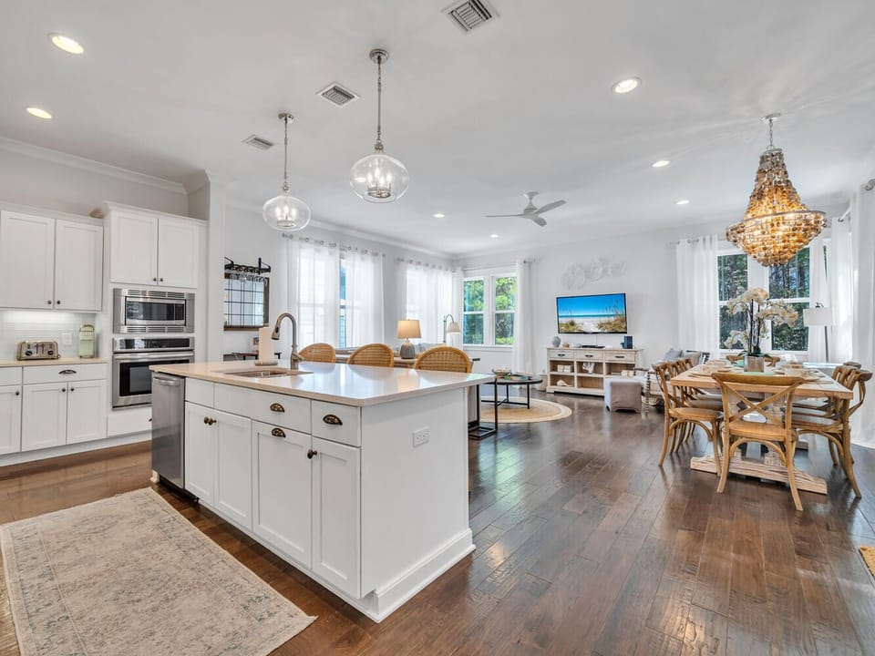 Your open-concept space flows from gourmet kitchen to cozy living and dining areas, perfect for gathering with loved ones under elegant chandeliers.