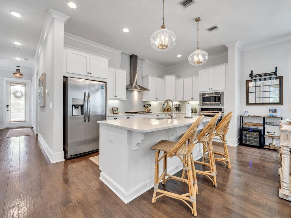 Your gourmet kitchen awaits with sparkling countertops, stainless appliances, and cozy island seating for morning coffee or evening wine.