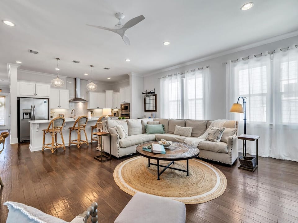 Settle into your spacious open-plan living room where rich hardwood floors meet a plush sectional sofa, perfect for relaxing after exploring.