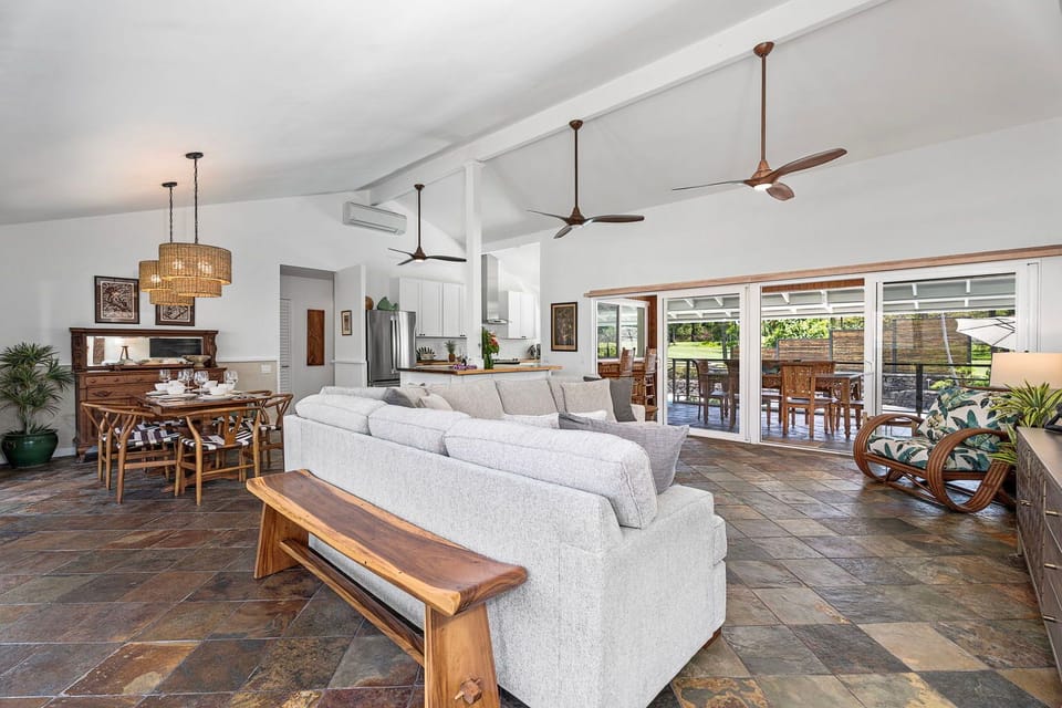 Vaulted ceilings rise over a living area built around the sectional and the Smart TV.