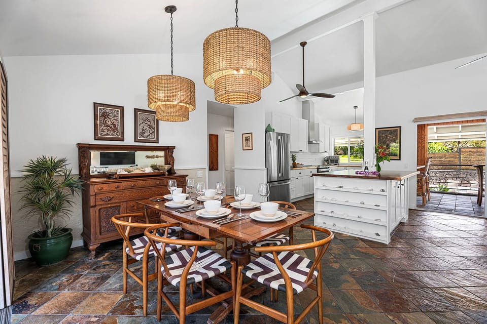 A woven pendant hangs over the table where the open plan keeps everyone together.