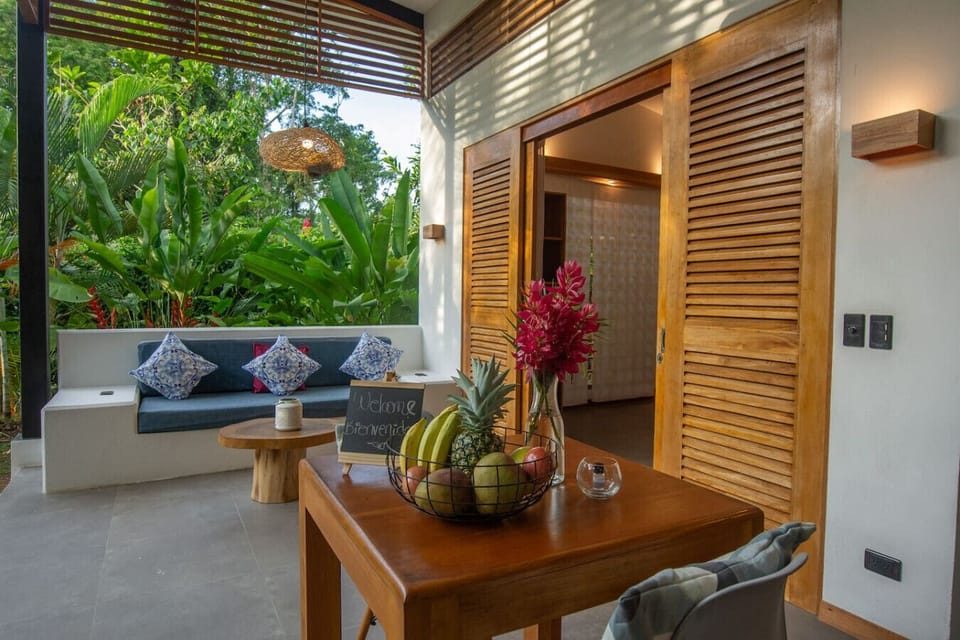 Open living and dining area with tropical garden views, Tres Lodge Lapa in Playa Chiquita, Costa Rica