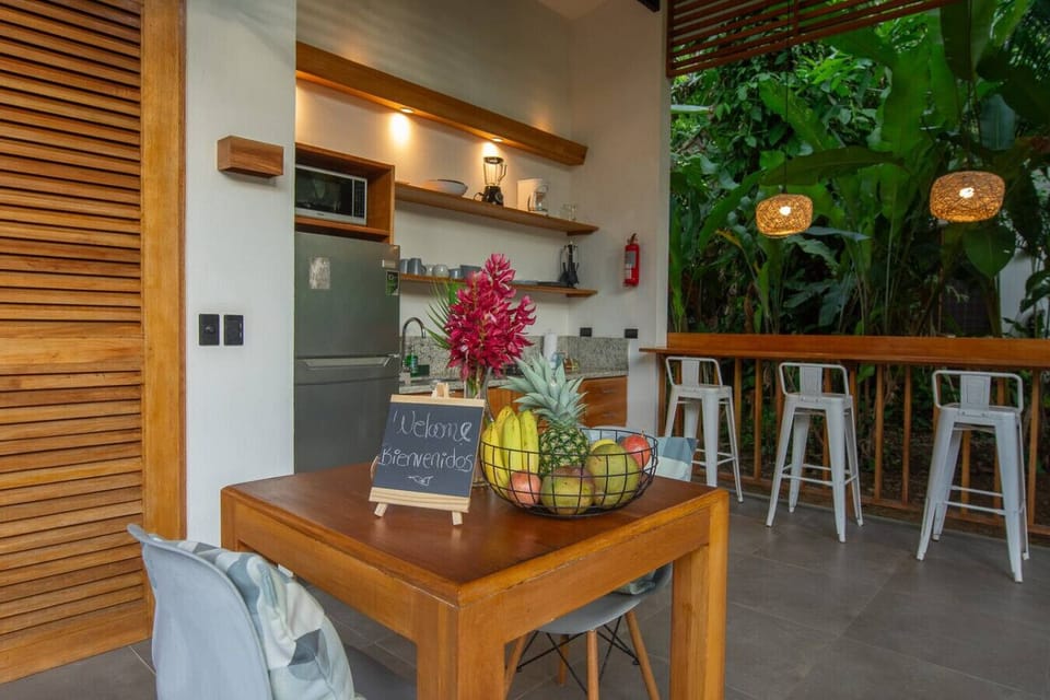Cozy dining area with fully equipped kitchen and tropical views, Tres Lodge Lapa in Playa Chiquita, Costa Rica