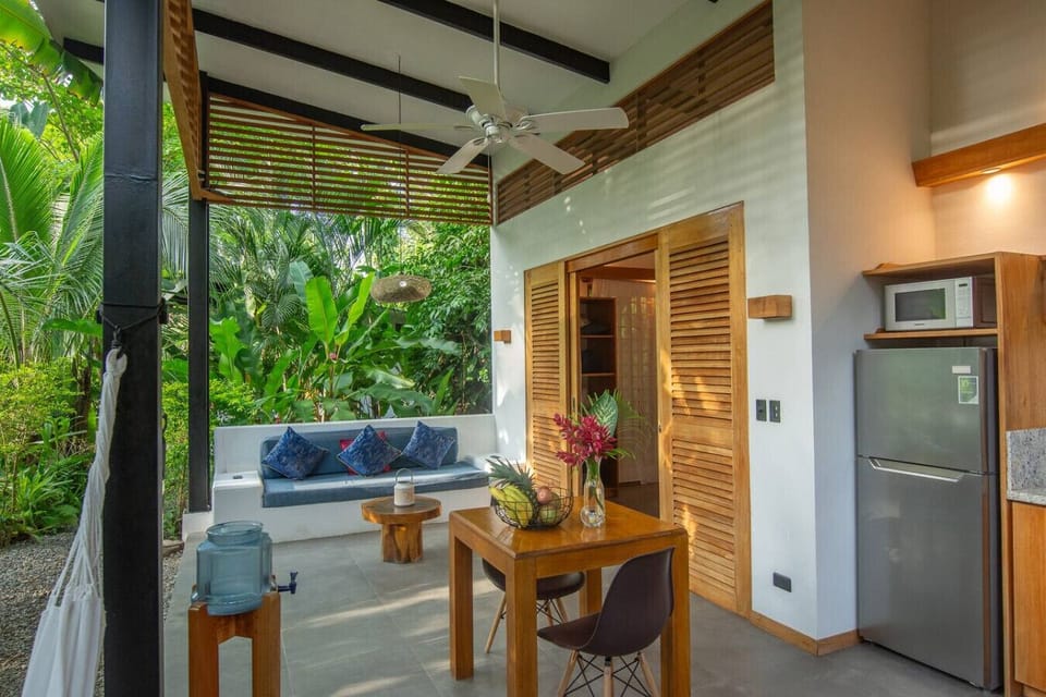 Open-air living area with kitchen and jungle views at Tres Lodge Tucan, Playa Chiquita