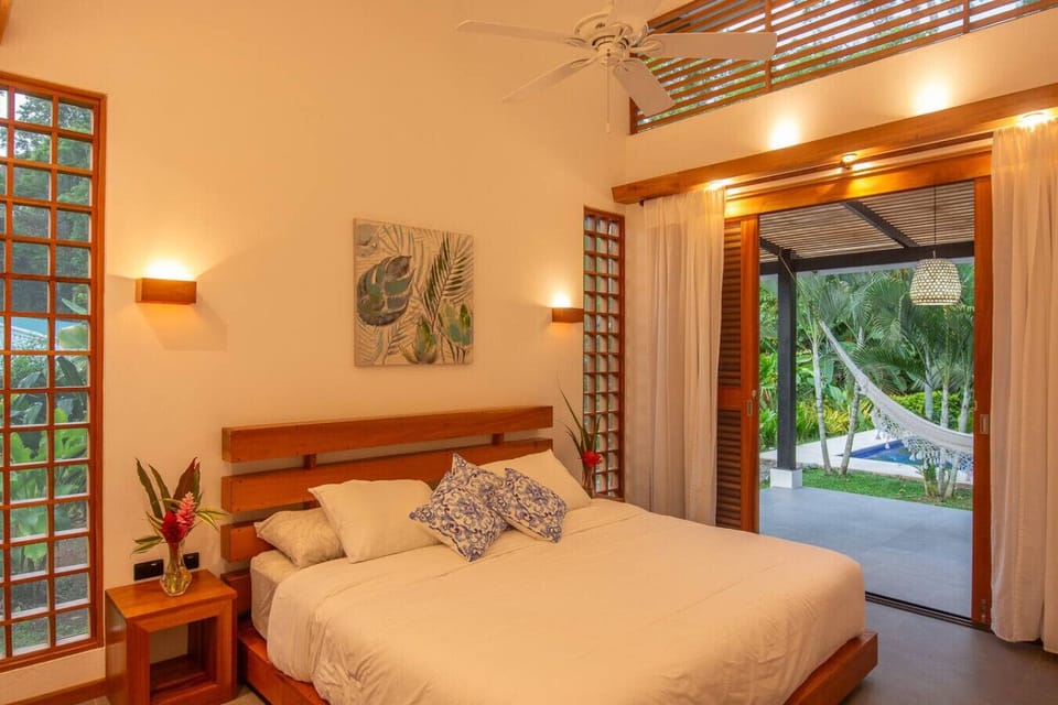 Master bedroom with king bed and direct access to the terrace with pool views, Tres Lodge Villa in Playa Chiquita, Costa Rica