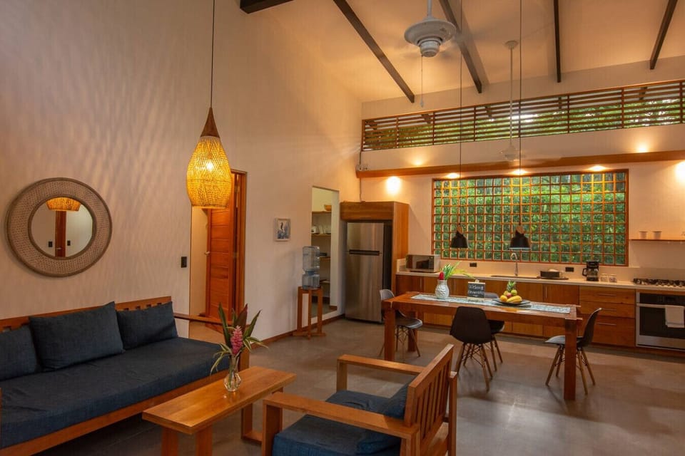 Living, dining and kitchen area with high ceilings and modern tropical design, Tres Lodge Villa in Playa Chiquita, Costa Rica